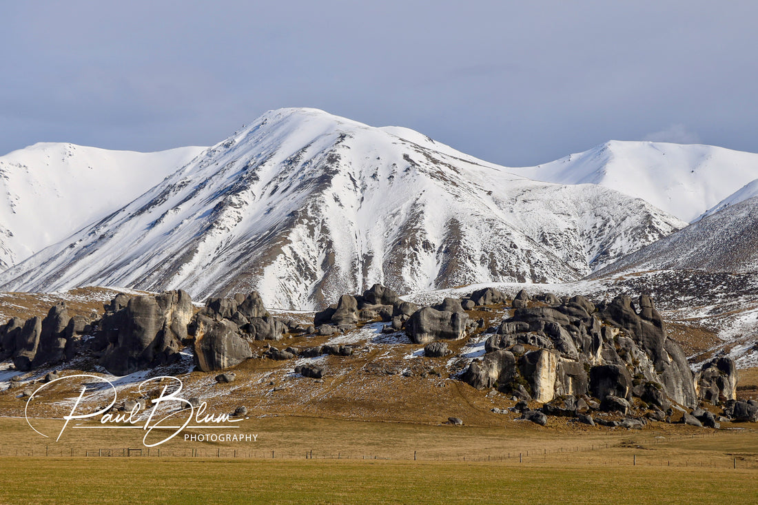 Stunning Contrasts: Snowy Peaks and Rugged Rocks.